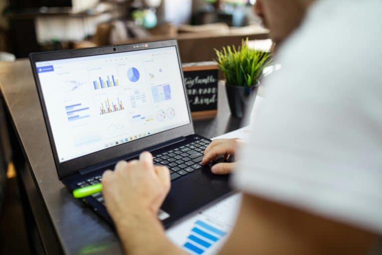 Freelance staffing dashboard on laptop showing analytics and workforce data